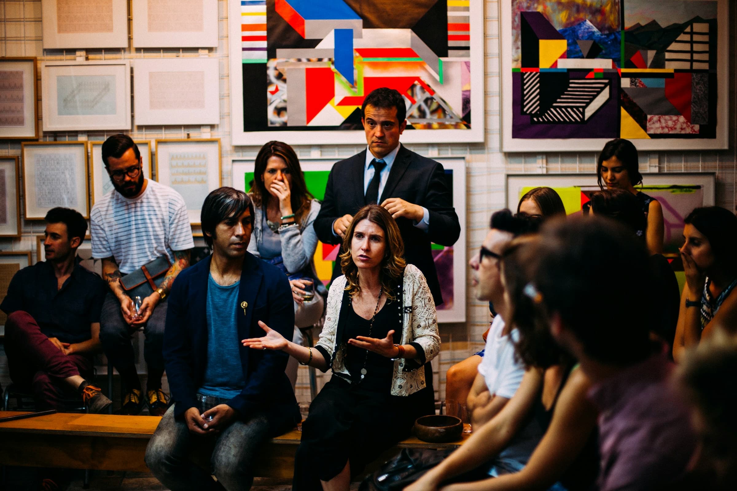 A community group in discussion in a gallery