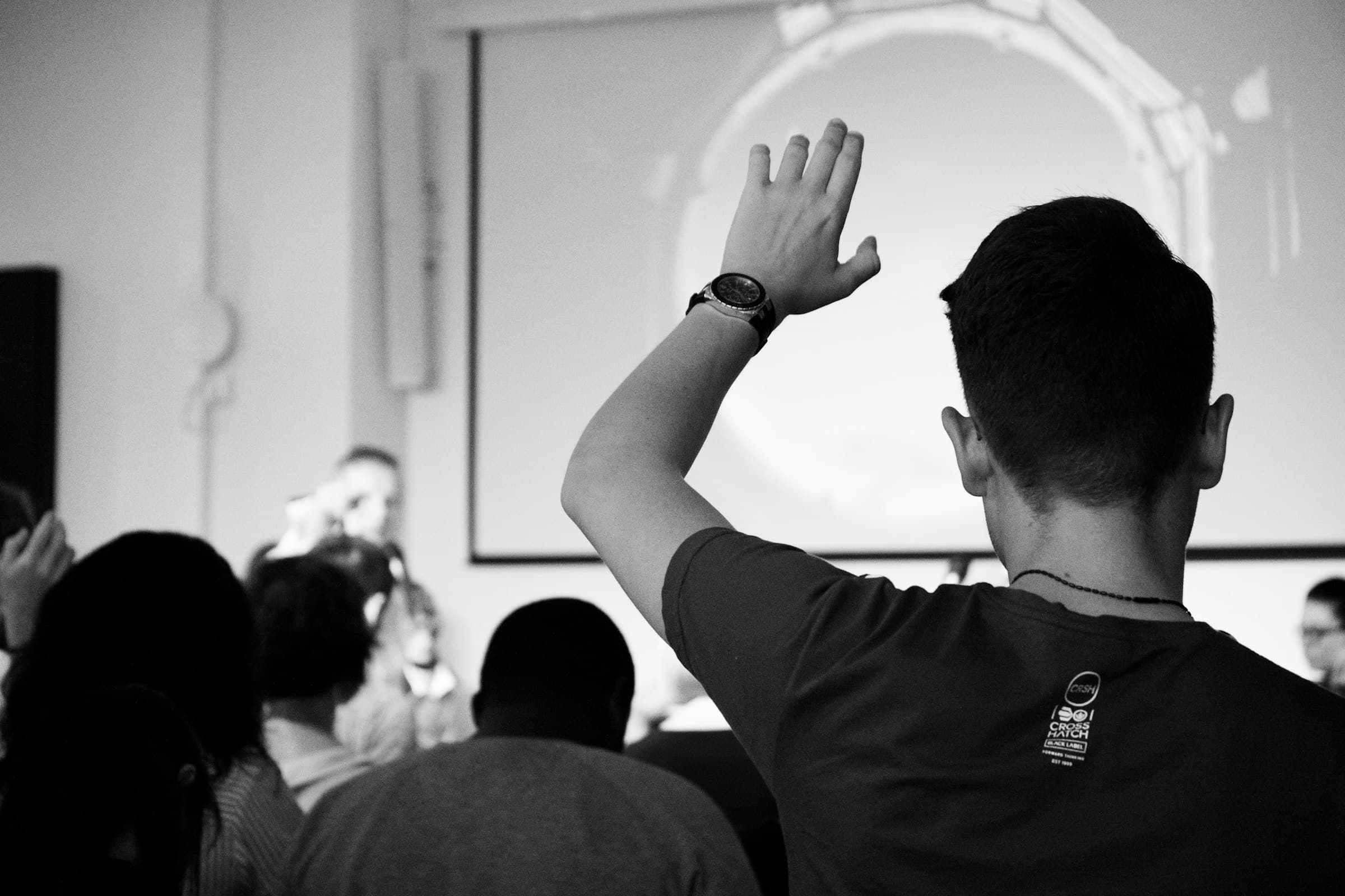 A man raising his hand in a meeting