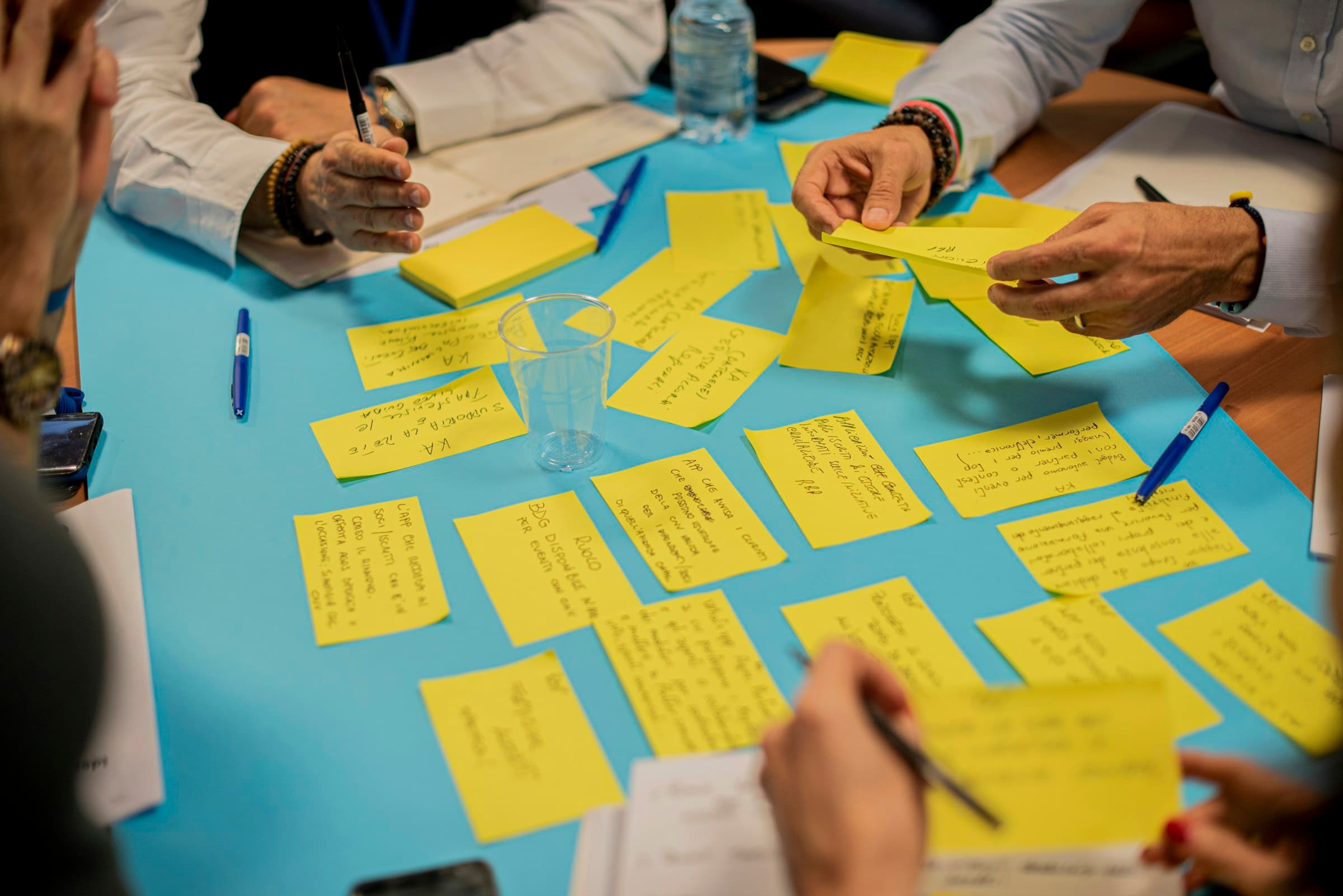 Hands arranging sticky notes during a workshop